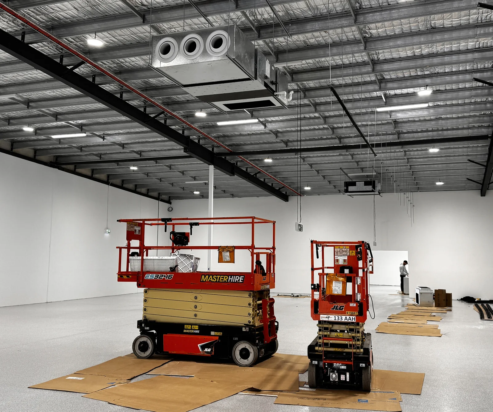 Commercial HVAC ductwork installation in a large retail warehouse space